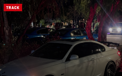 White BMW E92 at a nighttime car meet