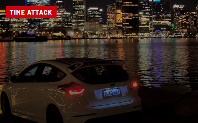 White Ford Focus RS beside the city at night